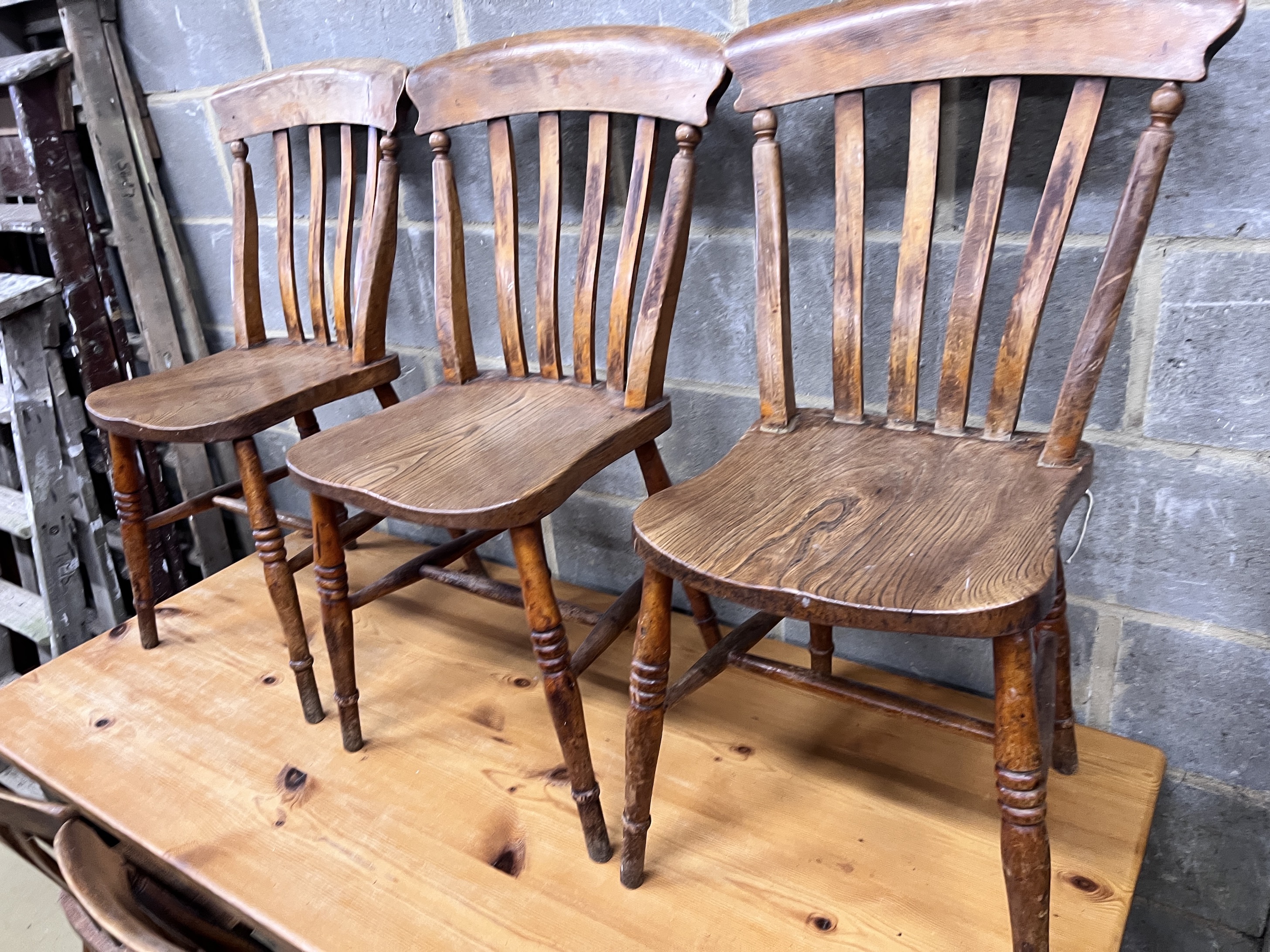 A Victorian style pine kitchen table with ebonised underframe, length 163cm, height 76cm and a set of six early 20th century lathe back kitchen chairs